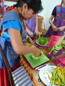 Nora shows us how to lay out squash blossoms and cheese balls in our soup bowls