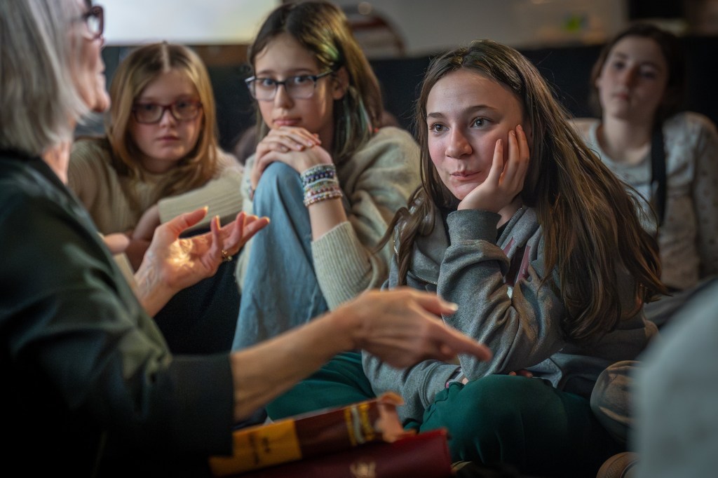 Young people engaged in disucssion on writing