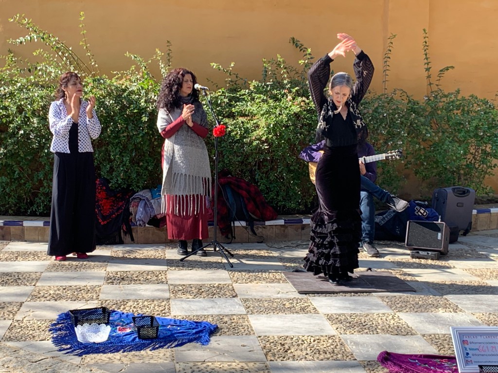 A person dancing, two people clapping.